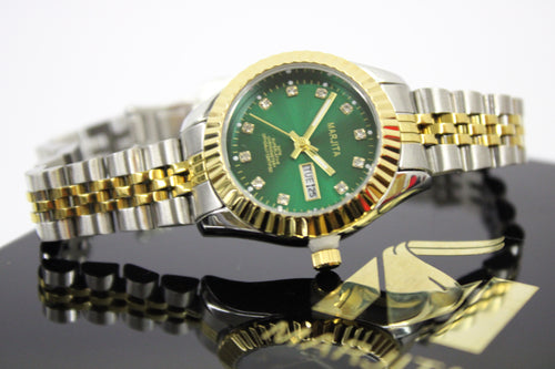 Luxury watch with green face and gold and silver band